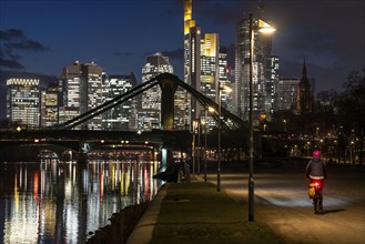 Skyline of the city centre of Frankfurt am Main, cyclist with light on the cycle path, pavement,