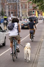 Cycle path on the Damrak shopping street, Amsterdam, Netherlands