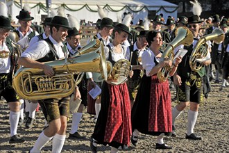 Musicians of a Bavarian brass band in traditional traditional costume with wind instruments,