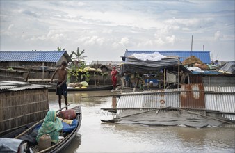 Morigaon, India. 4 July 2024. A settlement is partially submerged in flood in Morigaon district in