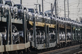 Car train, goods train on its way to the car terminal in Bremerhaven seaport, new German cars for