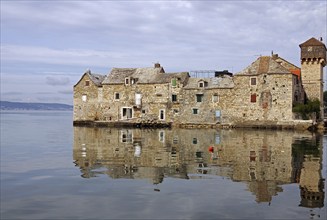 Old fortification from the Mediterranean reflected in the water, town of Kastela, Split, Dalmatia,