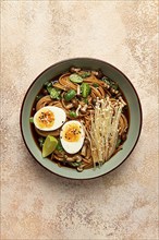 Soba, buckwheat noodles, with enoki mushrooms, shimeji and boiled egg, top view, homemade, no