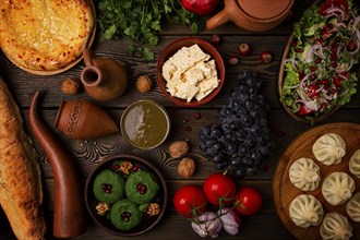 Traditional Georgian table, top view, Khinkali, Phali, Shoti, Khachapuri, Sauces, Fruits, nuts,