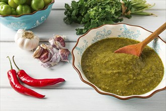 Tkemali sauce, traditional Georgian cuisine, green cherry plum, with ingredients for sauce,