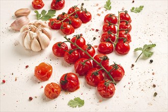 Baked branch, mini, cherry tomatoes, with spices and herbs, garlic, food background, top view, on a