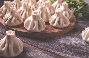 Raw khinkali, Traditional Georgian dish, on a wooden table, selective focus, rustic, no people