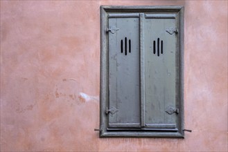 Window with closed shutters, red house facade, Baden-Württemberg, Germany, Europe