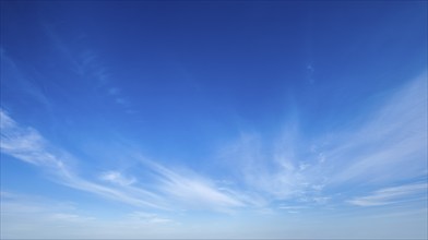 Clear Blue Sky with Whispy White Clouds, Perfect for Nature and Weather Backgrounds