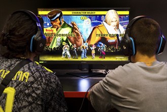 Two men in front of a screen with a computer role-playing game, Gamescom trade fair, the world's