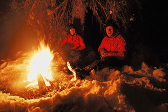 Two men around a campfire at night, Sweden, Scandinavia, Europe