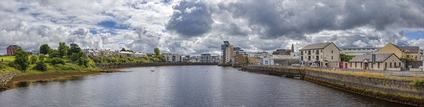 Panoramic view of a town along a river under a cloudy sky, Sligo