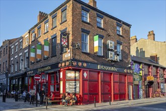 Pub in historic building with Irish flags in the evening light, Liverpool