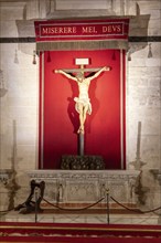 Altar with a red background and a crucifixion depiction of Jesus Christ, Seville