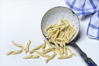 Strozzapreti, uncooked Italian pasta in a sieve, Italy, Europe