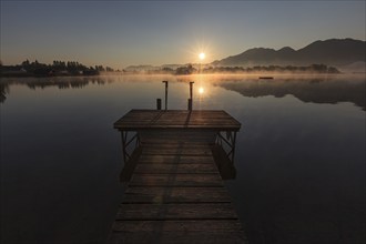 Footbridge on lake in front of mountains, sunrise, summer, silence, Lake Kochel, Alpine foothills,