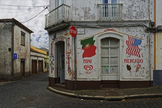 Corner of a street with a small shop and painted signs, deserted and quiet, Fenais da Luz, Sao