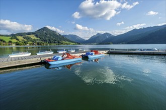 Electric boats and pedal boats at jetty, boat hire, Markt Schliersee, Schliersee, behind mountains