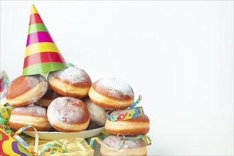 Colourful streamers, paper hats and doughnuts, carnival, copy room, white background