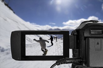 Close-up from a camcorder during video recording in a ski resort (composing)