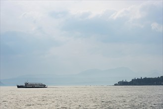 Historic ferry boat in the evening light, tourism, evening mood, sunset, Lake Garda, Malcesine,