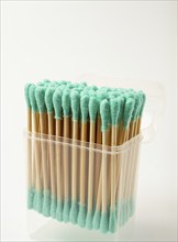 Bamboo cotton swabs, green, on a light background, in a package