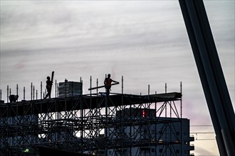 Workers dismantle scaffolding on the Erasmus Bridge over the Nieuwe Maas in Rotterdam, Netherlands