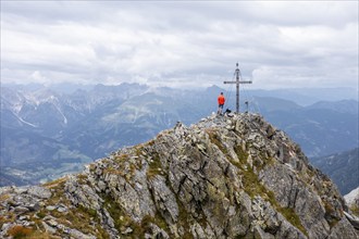 Aerial view, hiker on the Raudenspitze with summit cross, Carnic High Trail, Carnic Main Ridge,