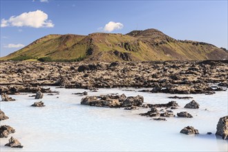 Thermal outdoor pool in front of volcanic mountains, Blue Lagoon, summer, sunny, Grindavik,