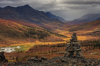 Autumn coloured tundra, mountains, clouds, Inukshuk, Tombstone Territorial Park, Dempster Highway,