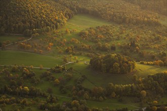 Volcanic embryo Hohbölle near Beuren. Autumnal Swabian Alb at sunset