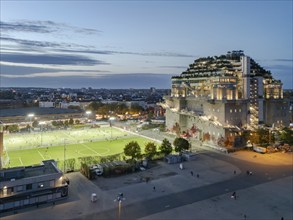 Aerial view of the Hamburg Bunker with green terraces and modern architecture in the evening