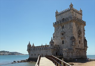 Medieval tower stands on a small promontory by the water, Torre de Belém, World Heritage Site,