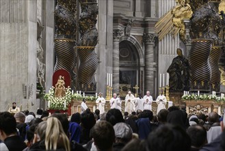 Pope Francis prays during Holy Mass in St Peter's Cathedral in the background columns of canopy by