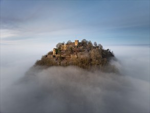 Aerial view of the Hegau volcano Hohentwiel with the upper fortress ruins illuminated by the rising