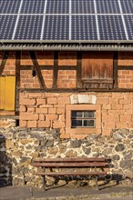 Historic farmhouse with photovoltaic system, solar panels on the roof, house wall with differently