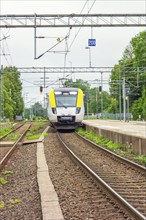 Commuter train entering a railway station, Sweden, Europe