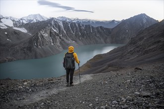 Mountaineer at Ala Köl mountain lake, in the Tien Shan Mountains, near Altyn Arashan, Kyrgyzstan,