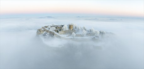 Aerial panorama of the Hegau volcano Hohentwiel with Germany's largest fortress ruins on a cold,