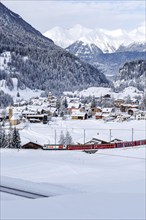 Rhaetian Railway train on the Albula railway Passenger train in the Alps in Bergün, Switzerland,