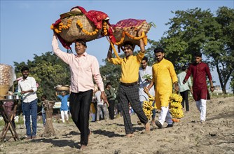 Hindu devotees perform rituals as they offer prayers to the Sun god in the bank of Brahmaputra