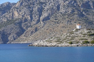 Old windmill on a rock, Bay of Panormitis, Symi, Dodecanese, Greece, Europe