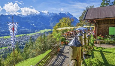 St. Martinshütte with restaurant terrace and view of the valley and Zugspitze group 2962m.