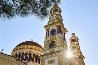 A large church tower with a monastery church, illuminated by bright sunlight, Church of Our Lady,