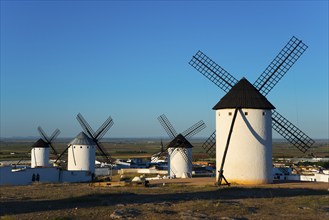 Group of white windmills in front of a vast landscape under a blue sky, Campo de Criptana, Ciudad