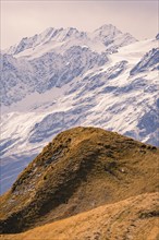 Snow-covered mountains with brown hills in the foreground, autumn scene, Planplatten, Switzerland,