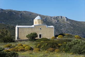 Church in a mountainous, green landscape under a clear sky, Chiesa di Agia Triada, church near