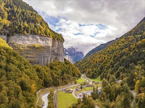 Panorama of a valley view with jagged rocks and autumnal forest, Switzerland, Europe