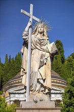 Monumental statue of a saint at the entrance to the Staglieno Monumental Cemetery, Cimitero