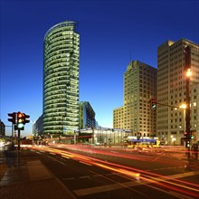 High-rise buildings at Potsdamer Platz, intersection with traffic lights and light traces of cars,